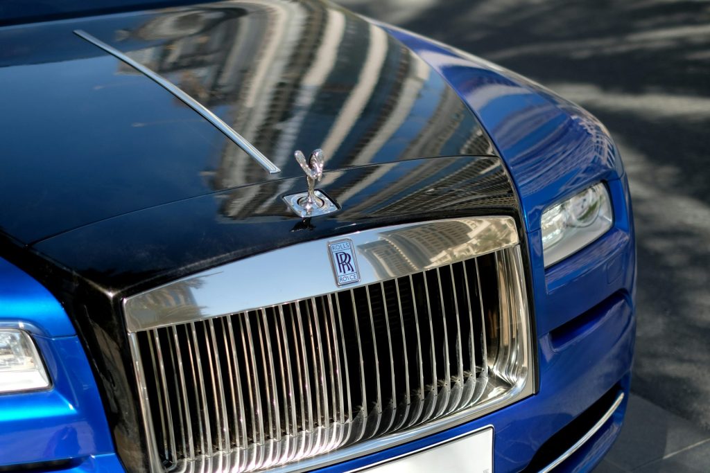 blue bmw car with silver and gold hood